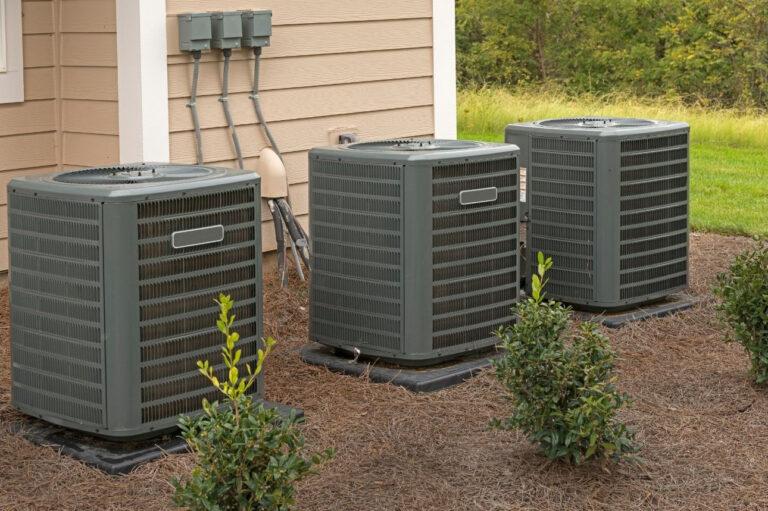 Three outdoor apartment building air conditioner units